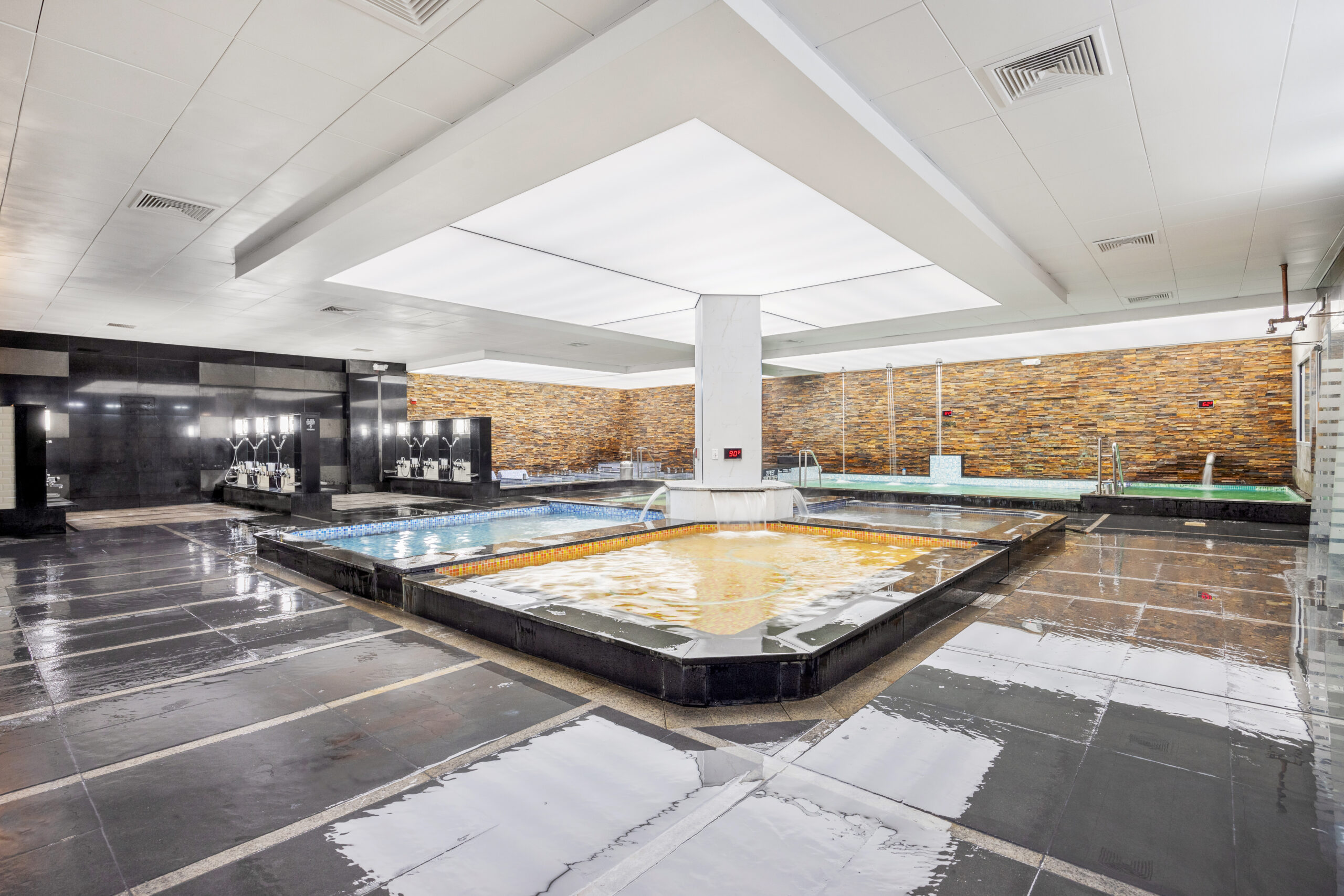 spa castle bath area, showing the showering area, seven hydrotherapy pools, dry and wet saunas.