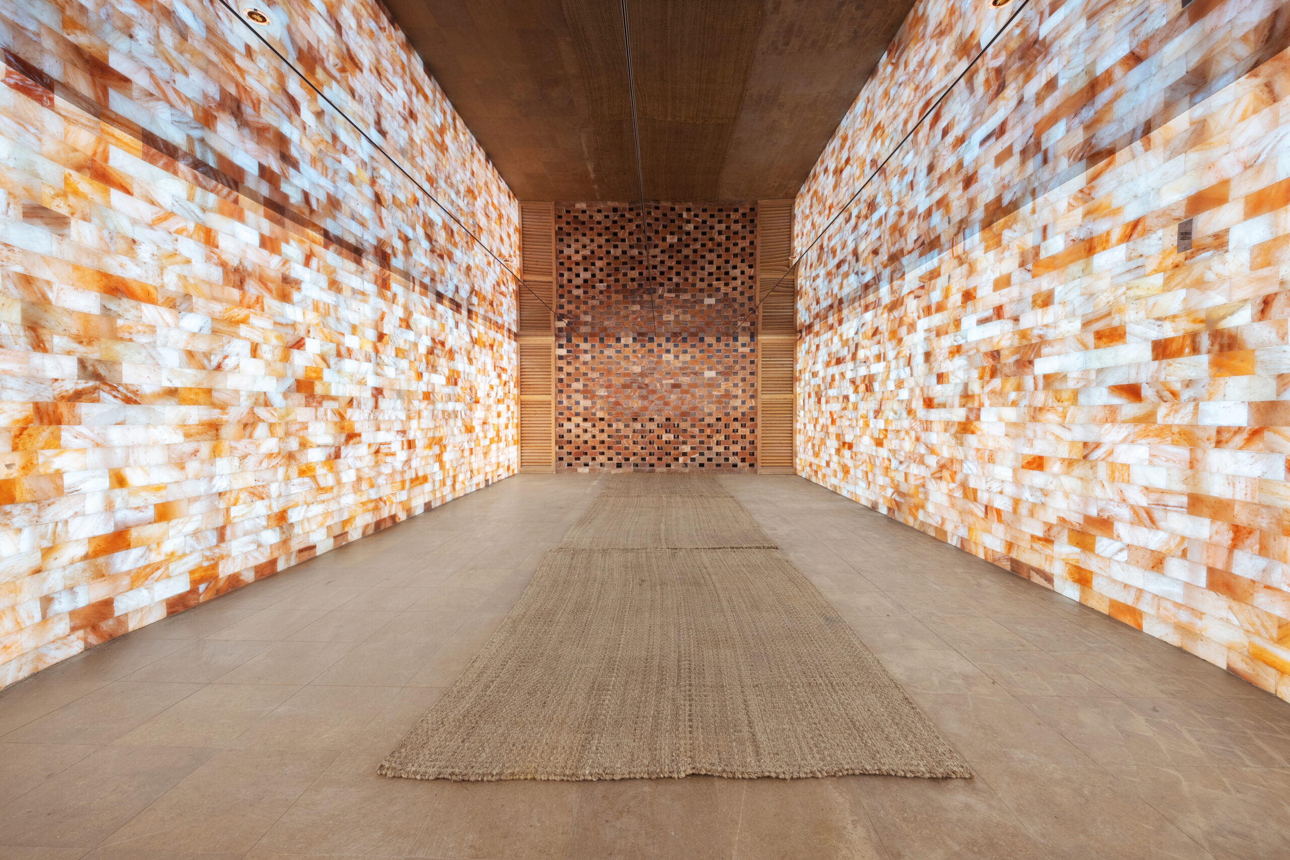 view of the entryway of Himalayan Salt Sauna. Showcasing the stacked salted Himalayan blocks that line the room,