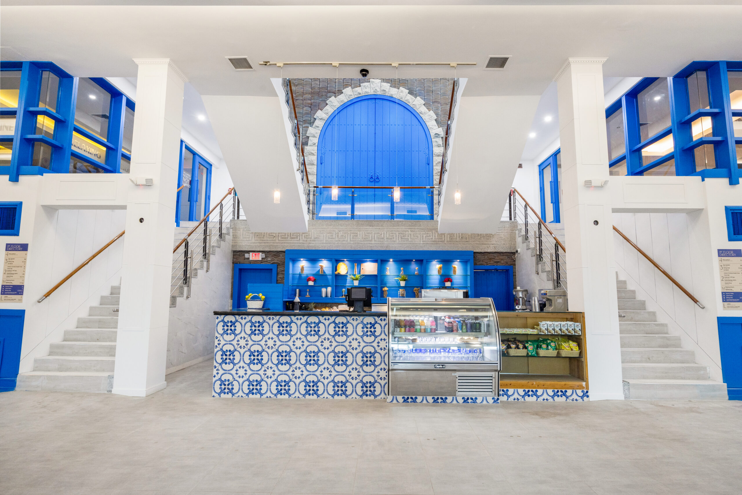 view of juice farm counter, featuring stairs leading up to the mezzanine and second floor.