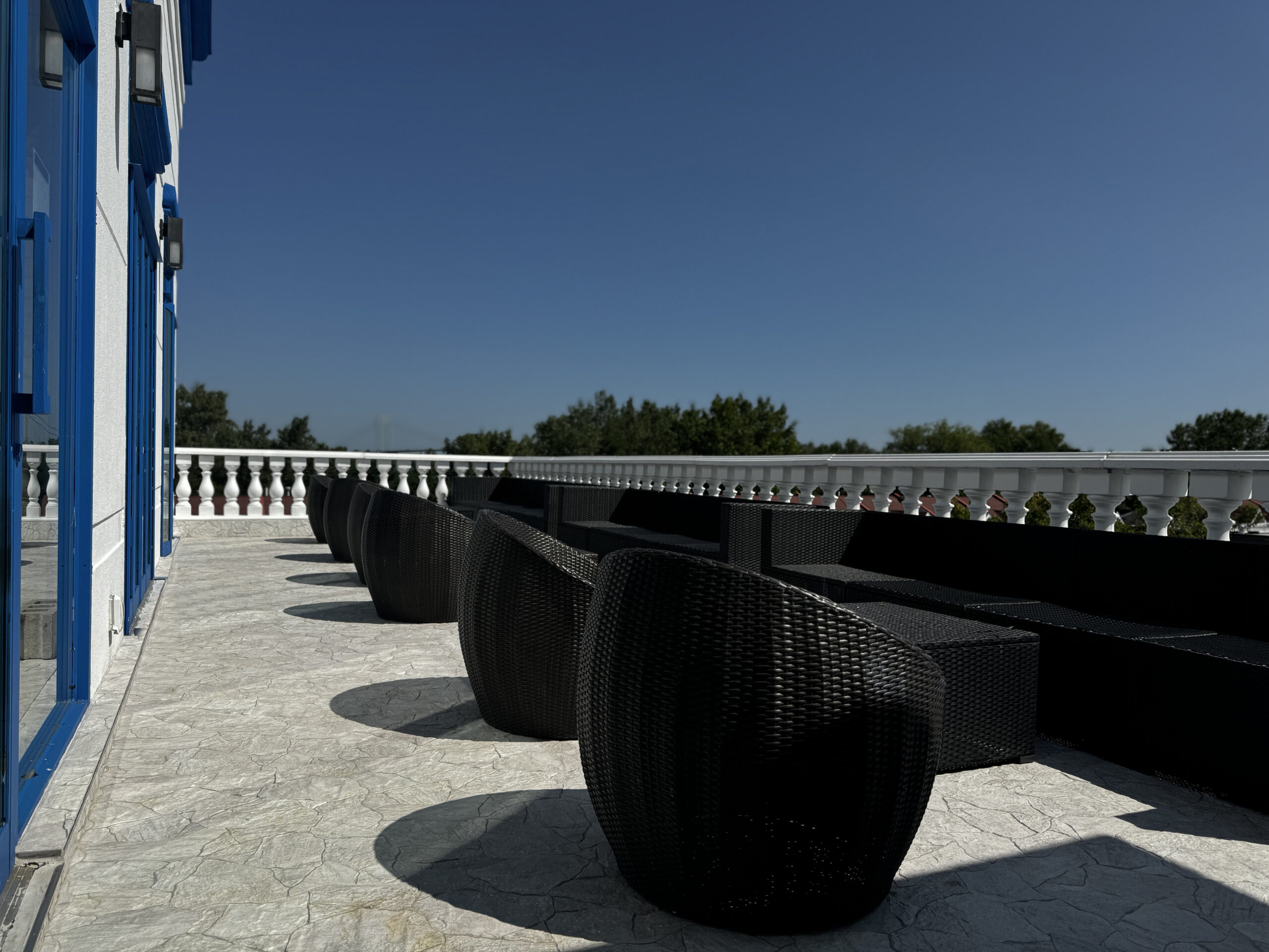 View of the outdoor sun lounge, featuring patio seating and chairs.