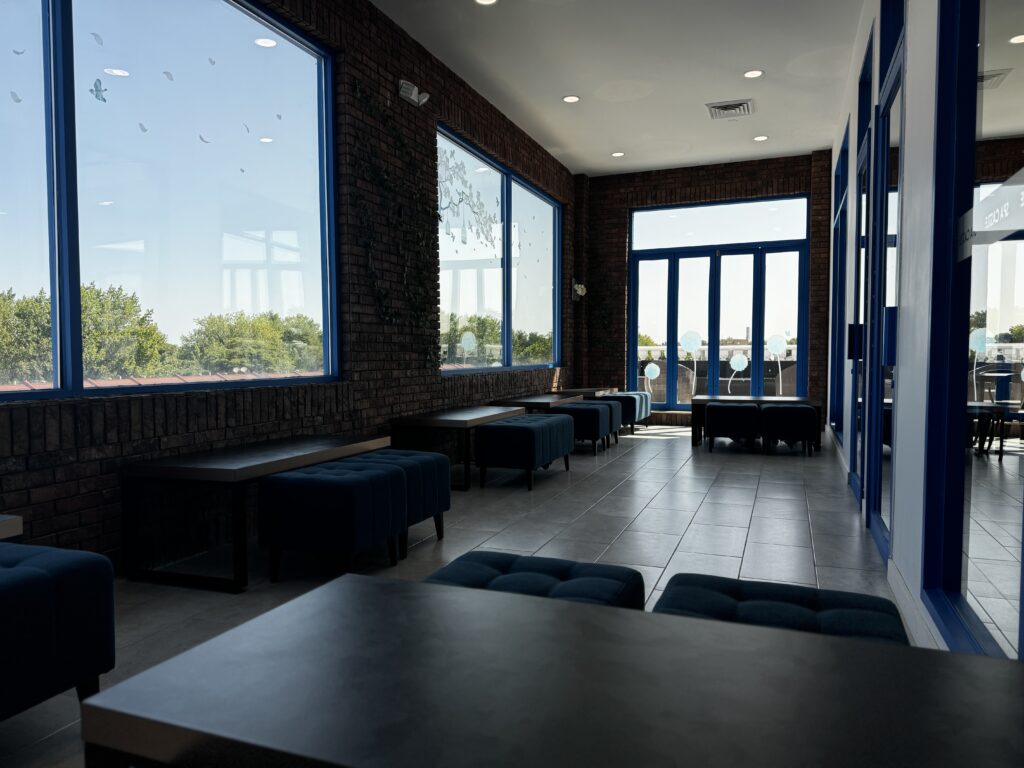 Inside view of quiet room, focusing on plus ottoman and small tables.