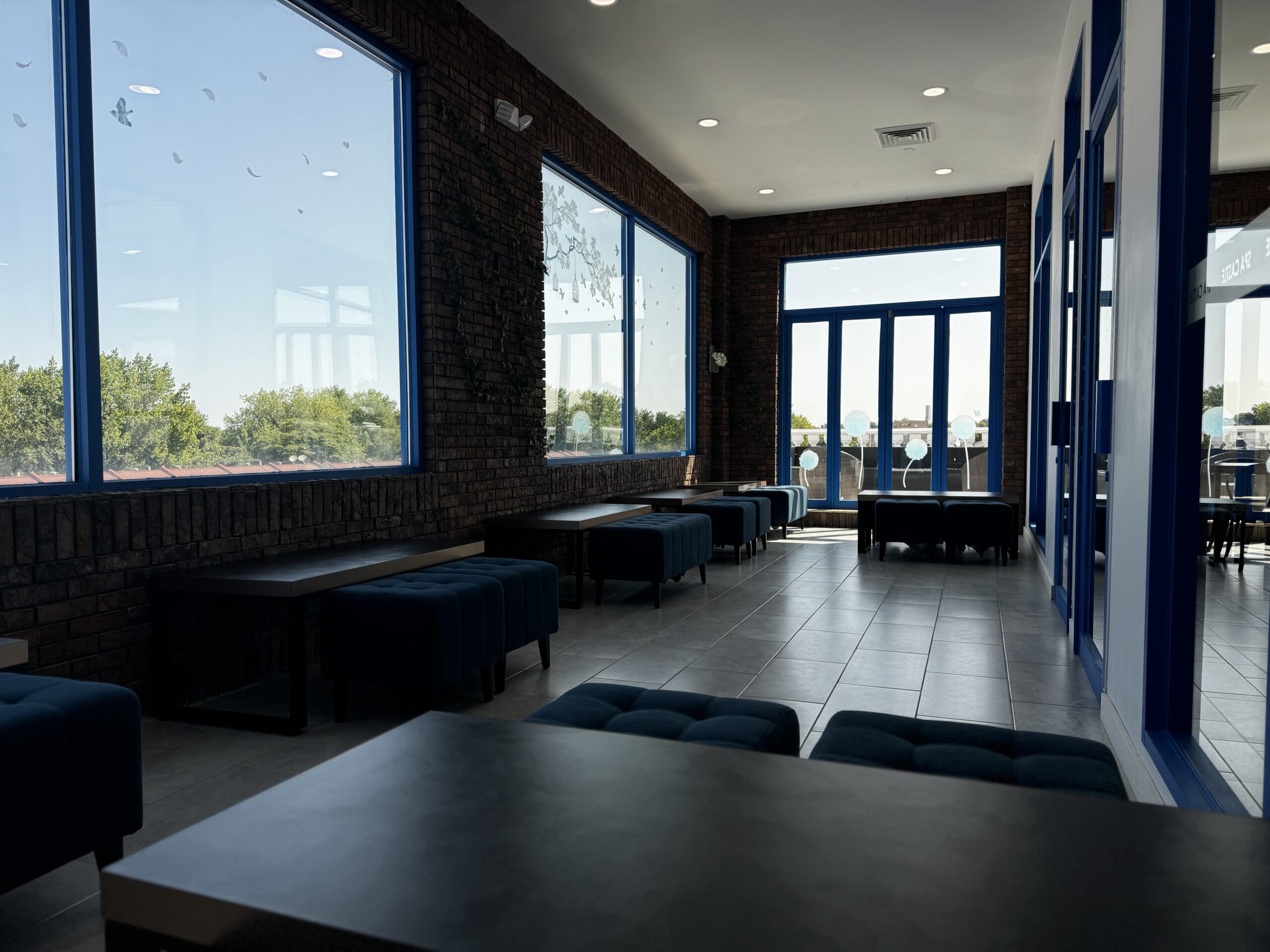 Inside view of quiet room, focusing on plus ottoman and small tables.