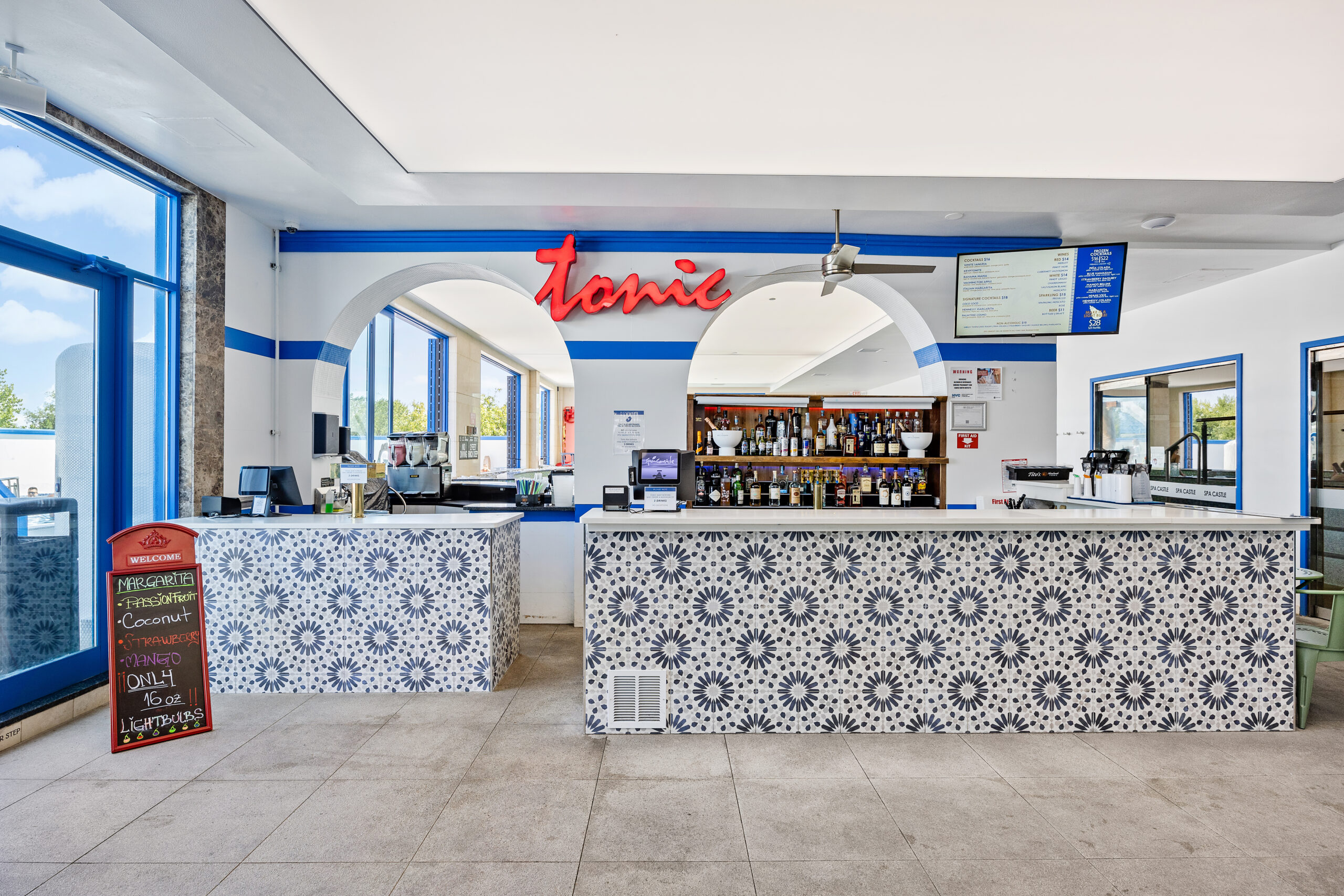 wide view of tonic bar, the aqua poolside bar. Displaying assortment of liquors and bar counter