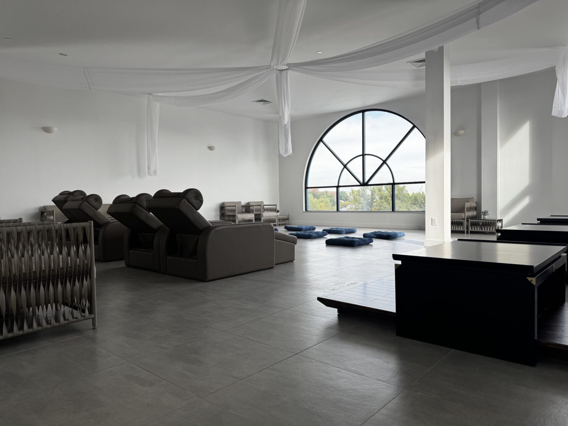 Inside of the Penthouse, focusing on the lounge seating, meditation pillows, and table seating.