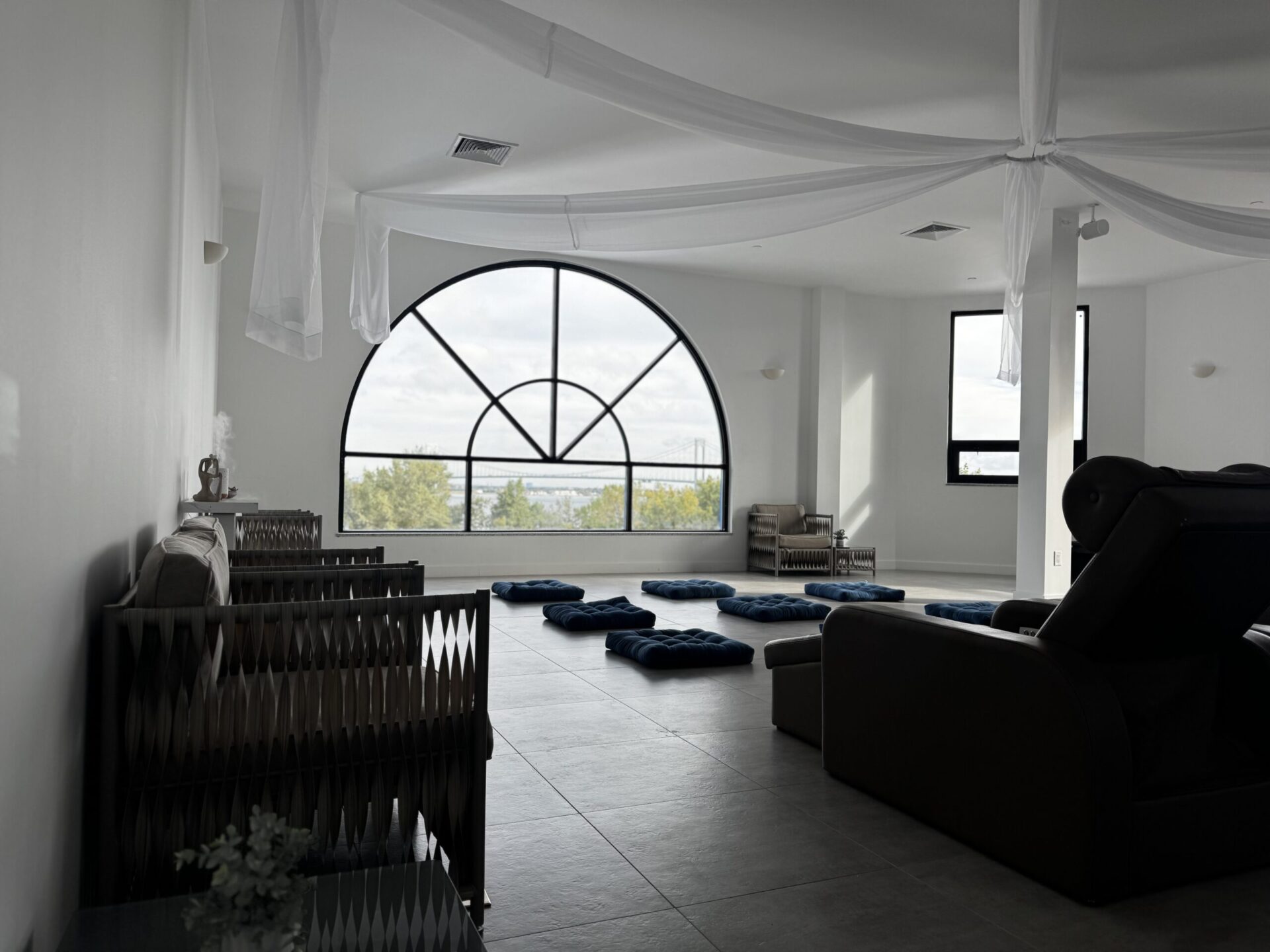 A comer view of the Penthouse , focusing on the lounge seating and meditation pillows.