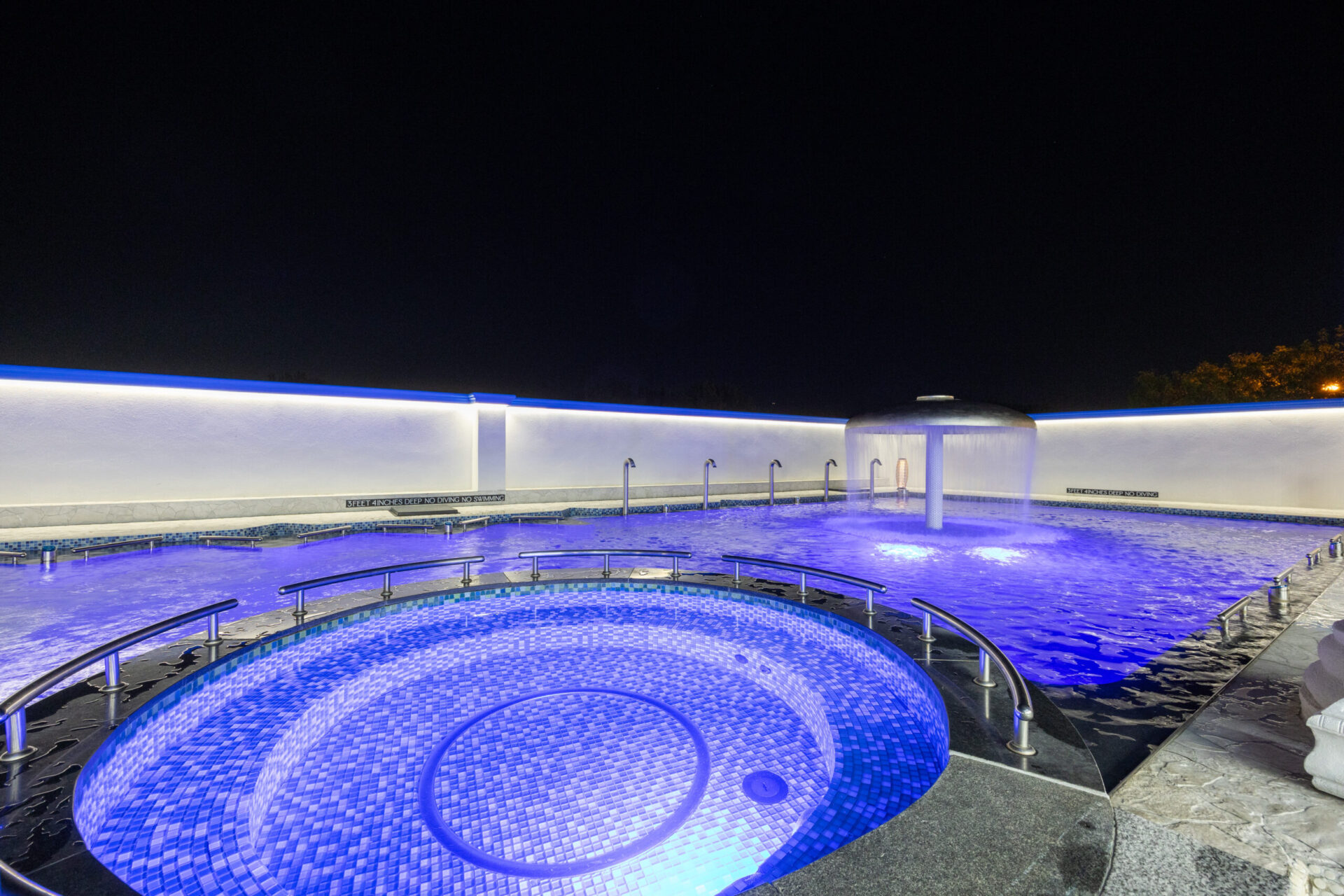 Nighttime view of the event bath station located inside the standing medi pool, in the outdoor area.